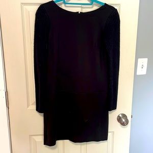 Black long sleeve dress with knit sleeves and golden zipper detailing